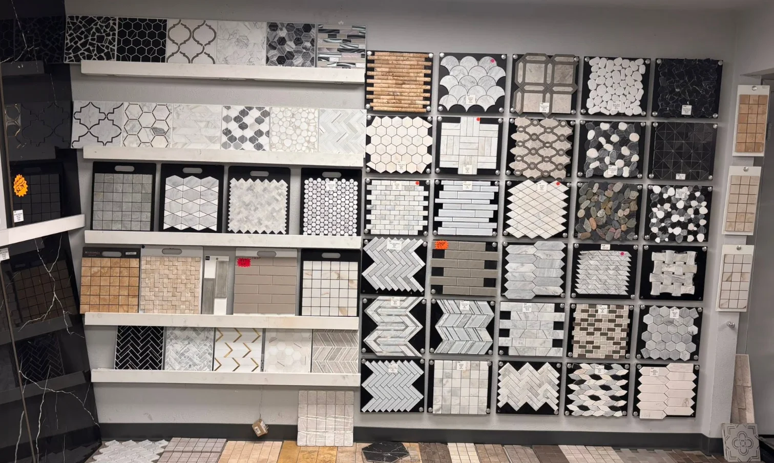 Tile showroom wall grid with many mosaic and stone samples