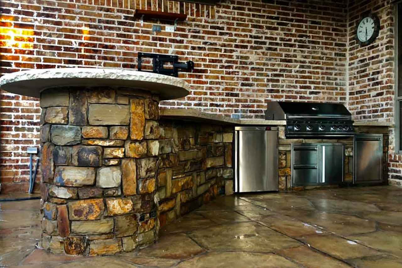 Stone Outdoor Kitchen with Bar & Cedar Patio Cover